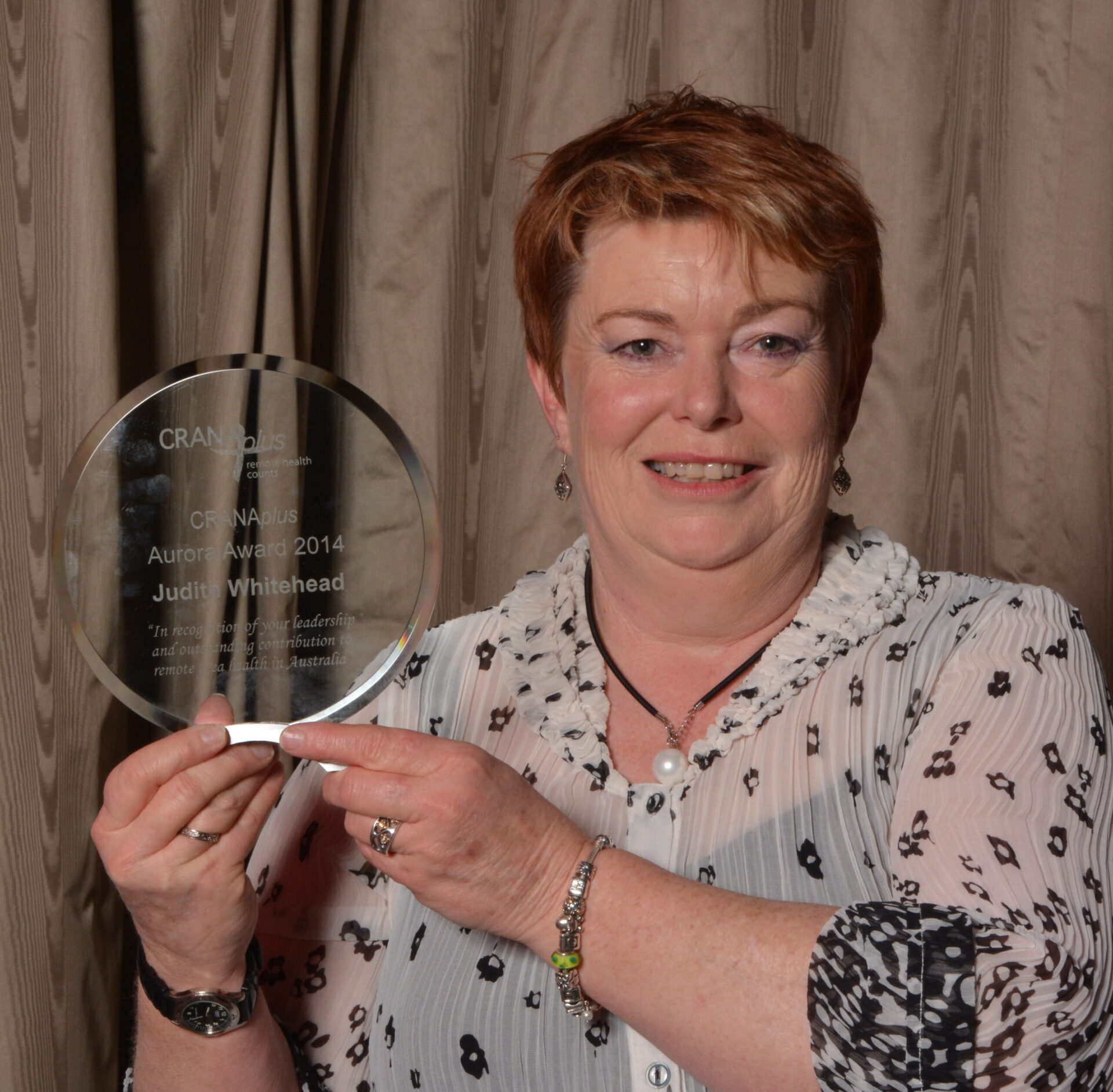 Judith holding her Aurora Award