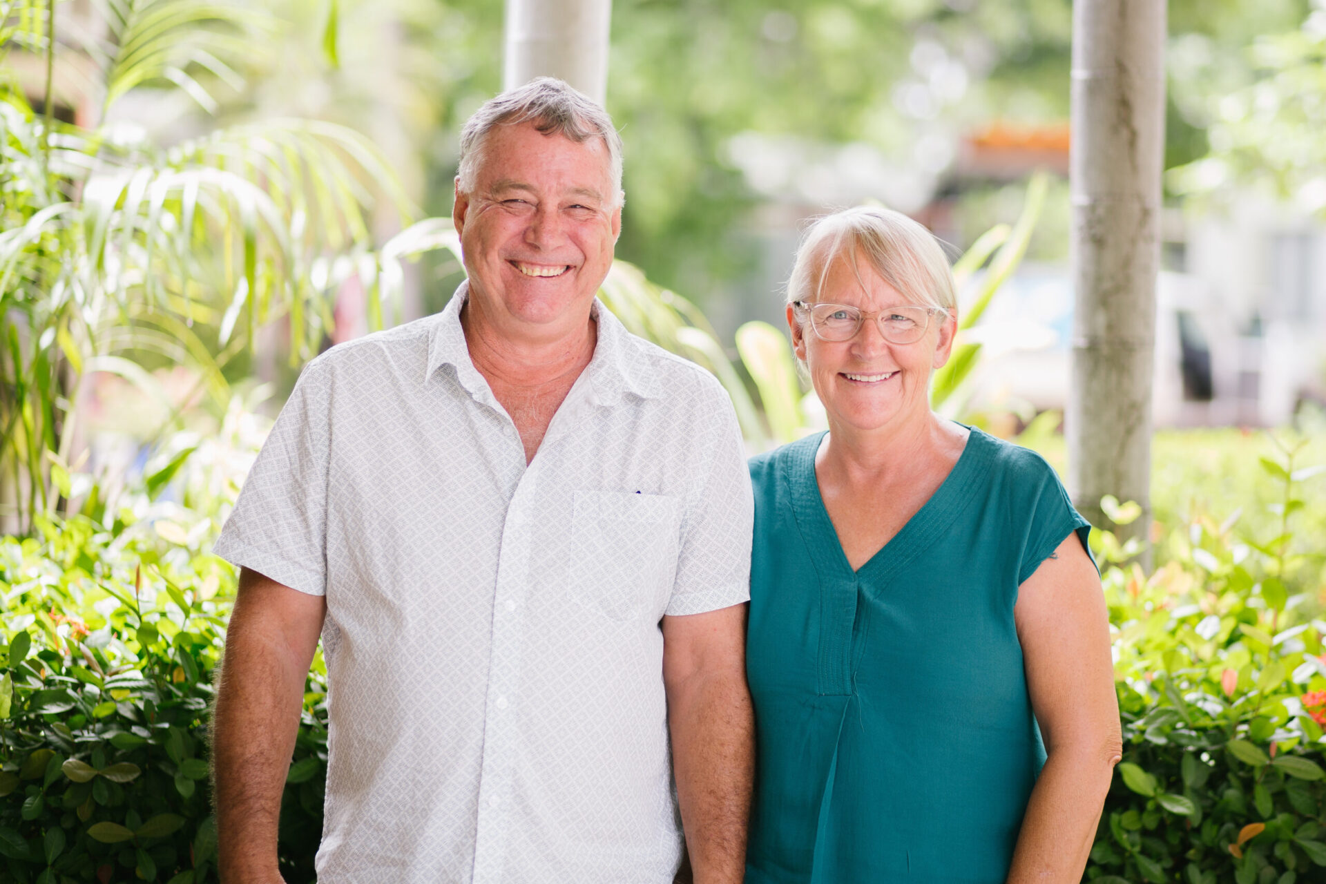 Phil and Sharon, standing side-by-side, smiling.