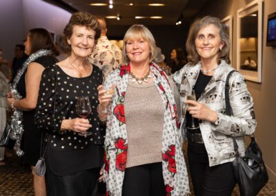 Group of people in formal attire stood smiling.