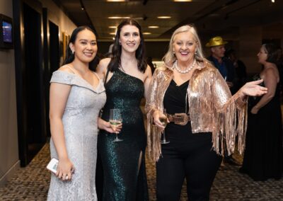 Group of people in formal attire stood smiling.