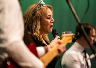 Person wearing tiara singing into microphone