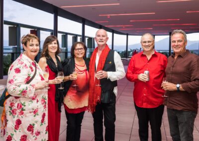 Group of people in formal attire stood smiling.