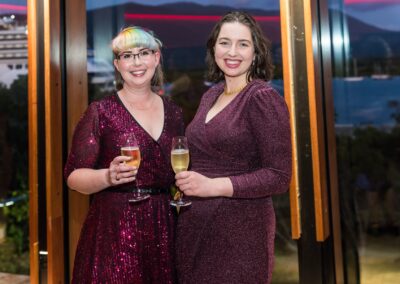 Group of people in formal attire stood smiling.