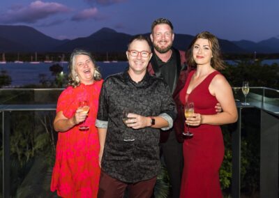 Group of people in formal attire stood smiling.