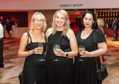 Group of people in formal attire stood smiling.