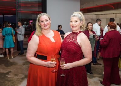 Group of people in formal attire stood smiling.