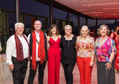 Group of people in formal attire stood smiling.