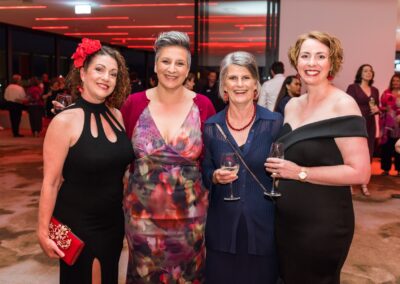 Group of people in formal attire stood smiling.